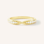 Gold ring with small diamonds on a white background