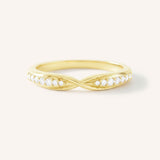 Gold ring with small diamonds on a white background