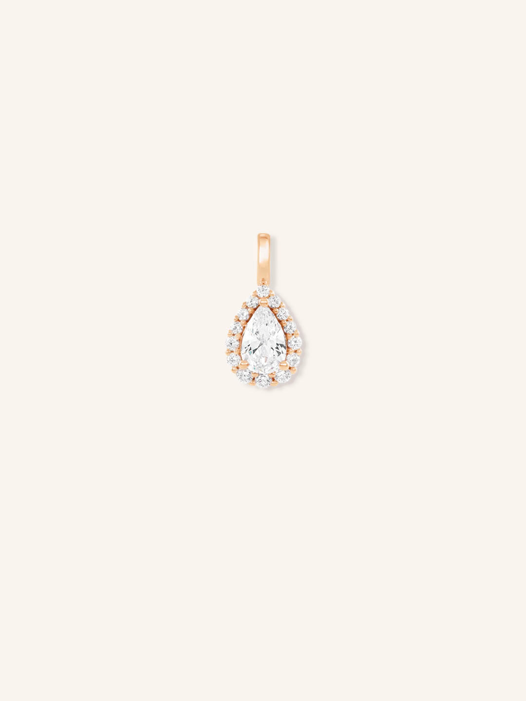 A gold-tone pendant featuring a pear-shaped diamond centerpiece encircled by smaller diamonds, set against a plain background.