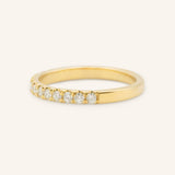 Gold ring with small diamonds on a white background