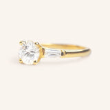 Stately Manor Round Moissanite Tapered Baguette Three Stone Engagement Ring