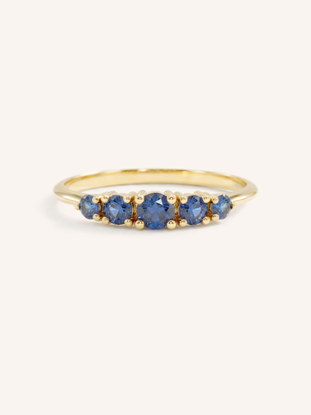 Yellow gold Lovett five stone blue sapphire anniversary ring front view on white background