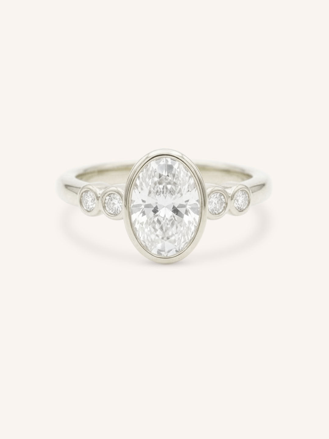White gold Alameda oval bezel set diamond engagement ring front view on white background