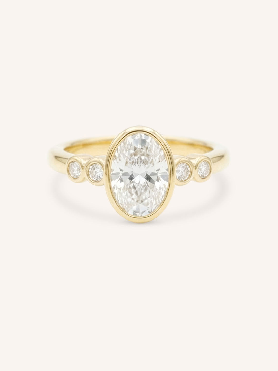 Yellow gold Alameda oval bezel set diamond engagement ring front view on white background