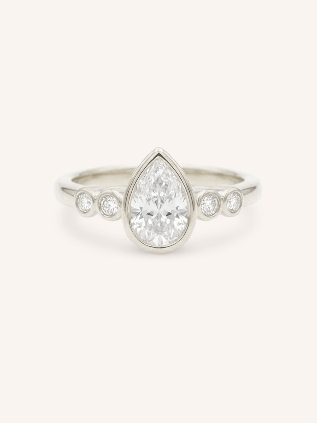 White gold Alameda pear bezel set diamond engagement ring front view on white background