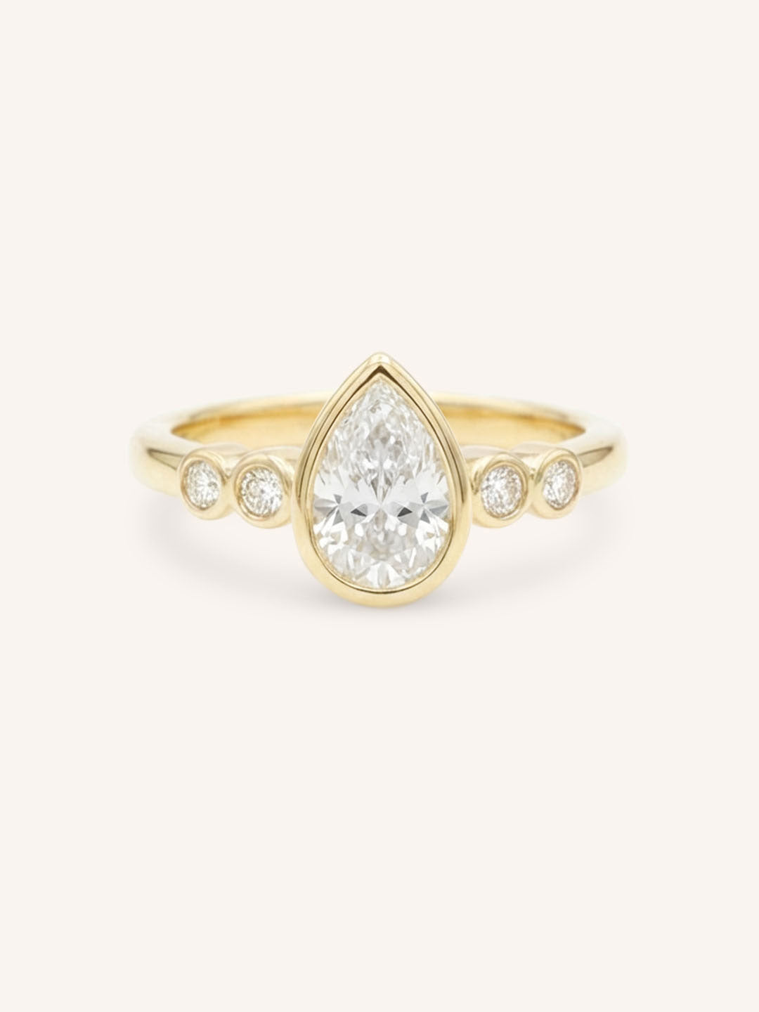 Yellow gold Alameda pear bezel set diamond engagement ring front view on white background