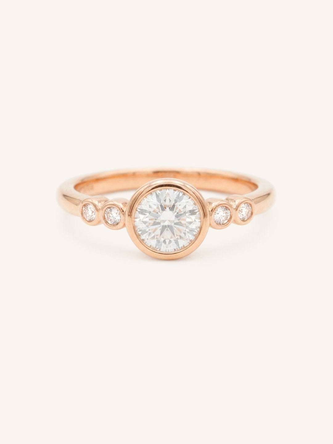 Rose gold Alameda round diamond bezel set engagement ring front view on white background