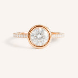 Rose gold round cut bezel set accented diamond engagement ring front view on white background