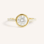 Yellow gold round cut bezel set accented diamond engagement ring front view on white background