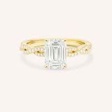 Yellow Gold Levana Emerald Cut Diamond Twist Accented Engagement Ring front view on white background