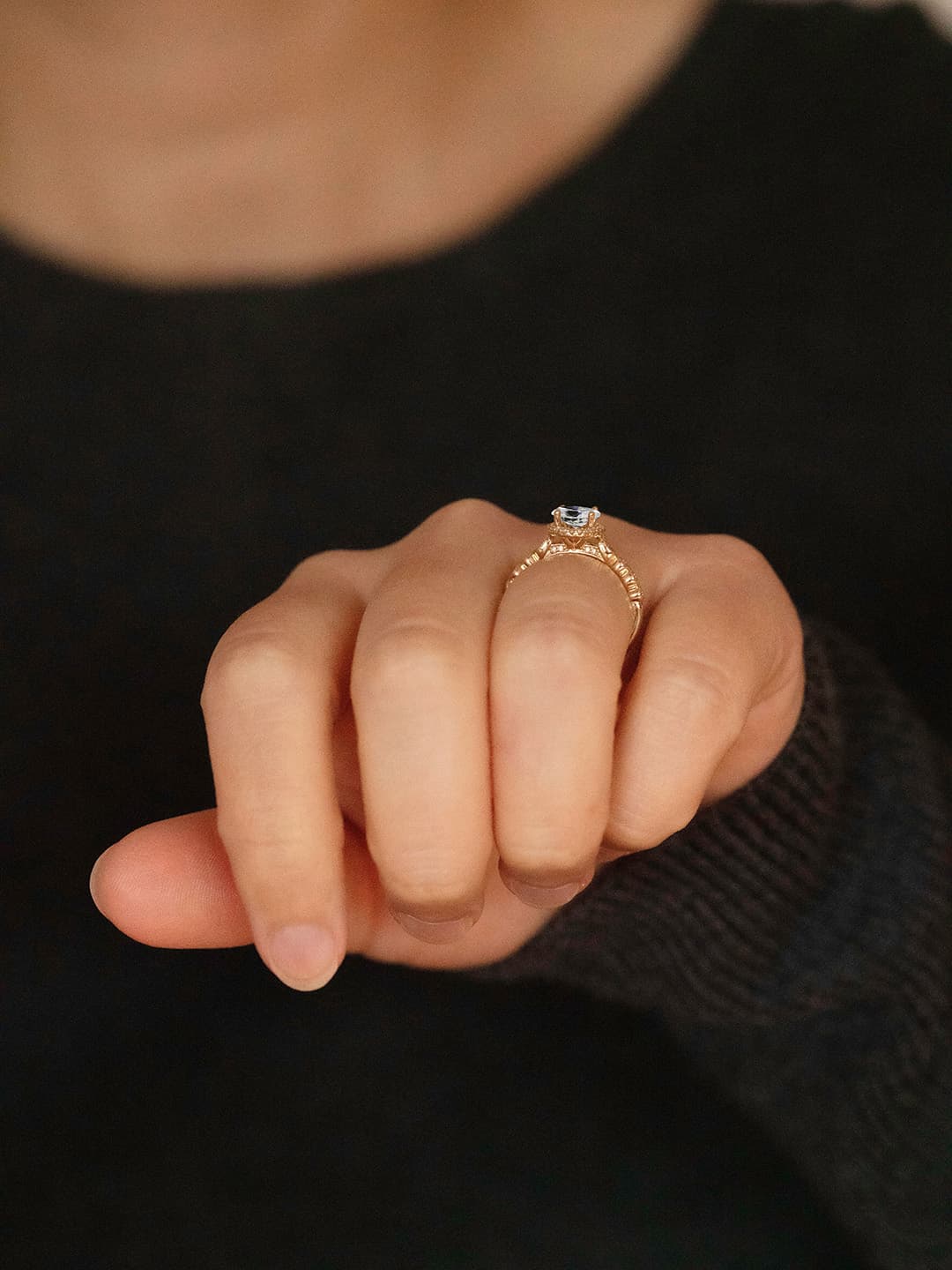 Claire oval diamond halo vintage style engagement ring lifestyle photo worn on hand