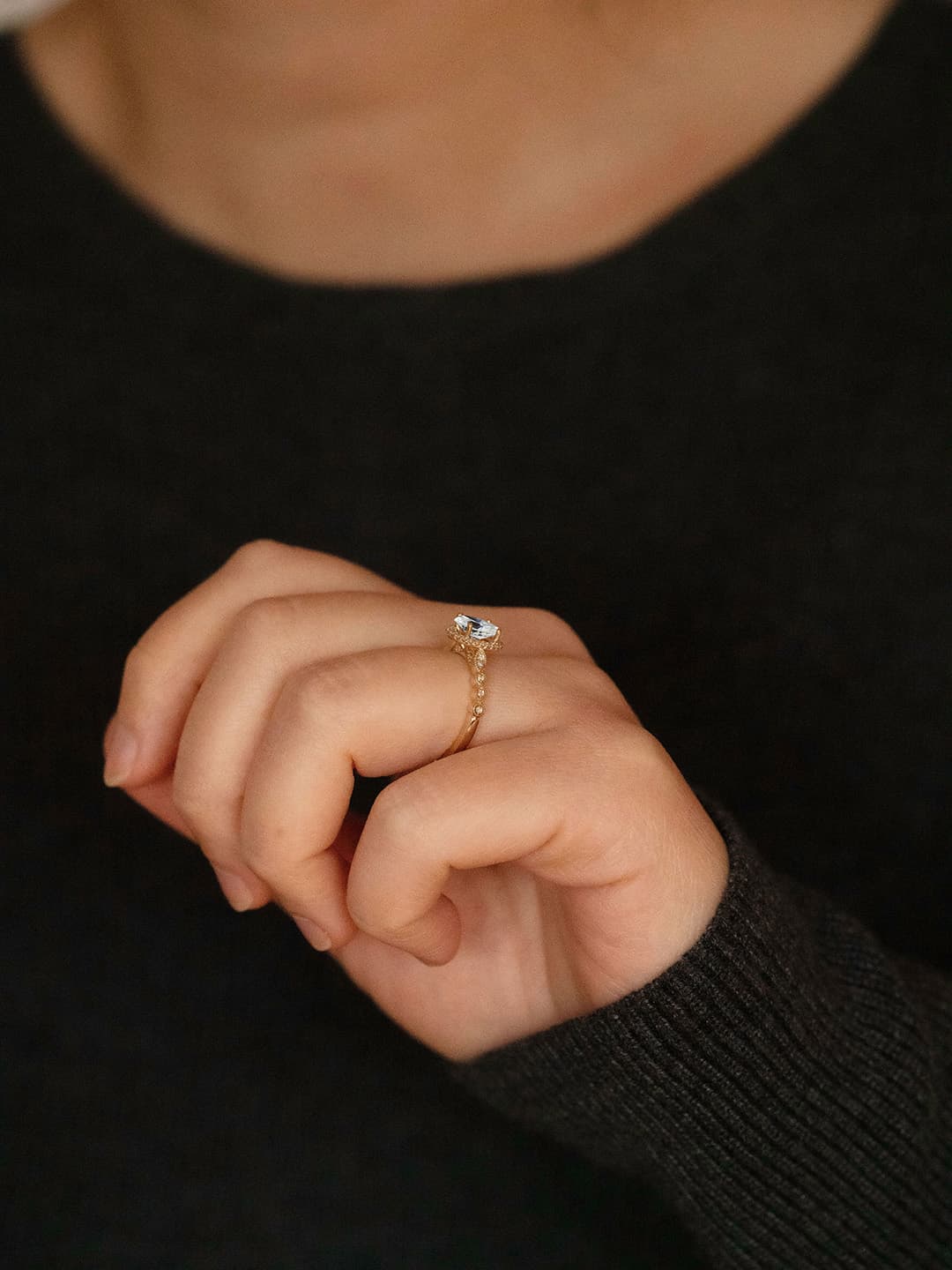 Claire oval diamond halo vintage style engagement ring lifestyle photo worn on hand