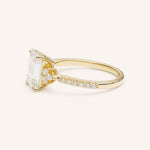 Yellow Gold emerald cut diamond engagement ring with pave band side view on white background