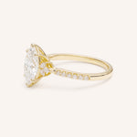 Yellow Gold marquise diamond engagement ring with pave band side view on white background