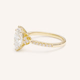 Yellow Gold marquise diamond engagement ring with pave band side view on white background