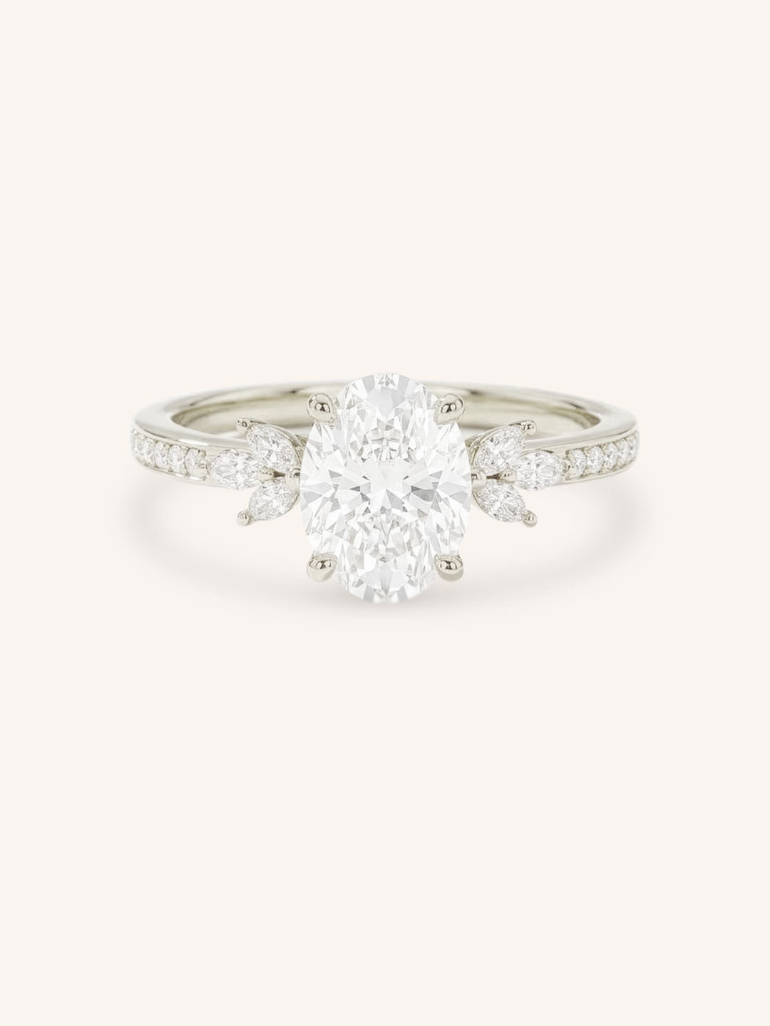 White gold oval-cut diamond engagement ring with marquise diamond accents on white background