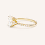 Yellow Gold oval diamond engagement ring with pave band side view on white background