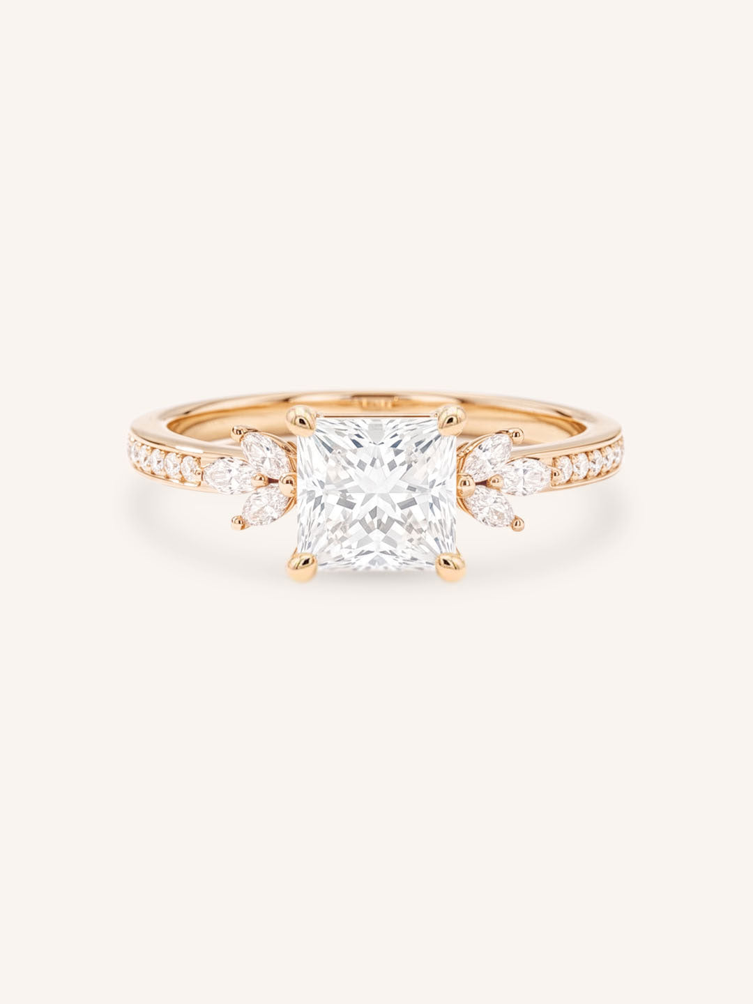 Rose gold princess-cut diamond engagement ring with marquise diamond accents on white background