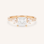 Rose gold princess-cut diamond engagement ring with marquise diamond accents on white background