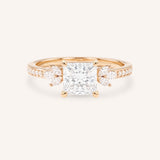 Rose gold princess-cut diamond engagement ring with marquise diamond accents on white background