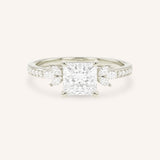 White gold princess-cut diamond engagement ring with marquise diamond accents on white background
