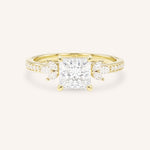 Yellow gold princess-cut diamond engagement ring with marquise diamond accents on white background