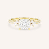 Yellow gold princess-cut diamond engagement ring with marquise diamond accents on white background