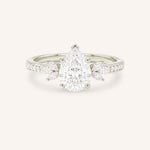 White gold pear-cut diamond engagement ring with leaf-shaped diamond accents on the band, front view on white background