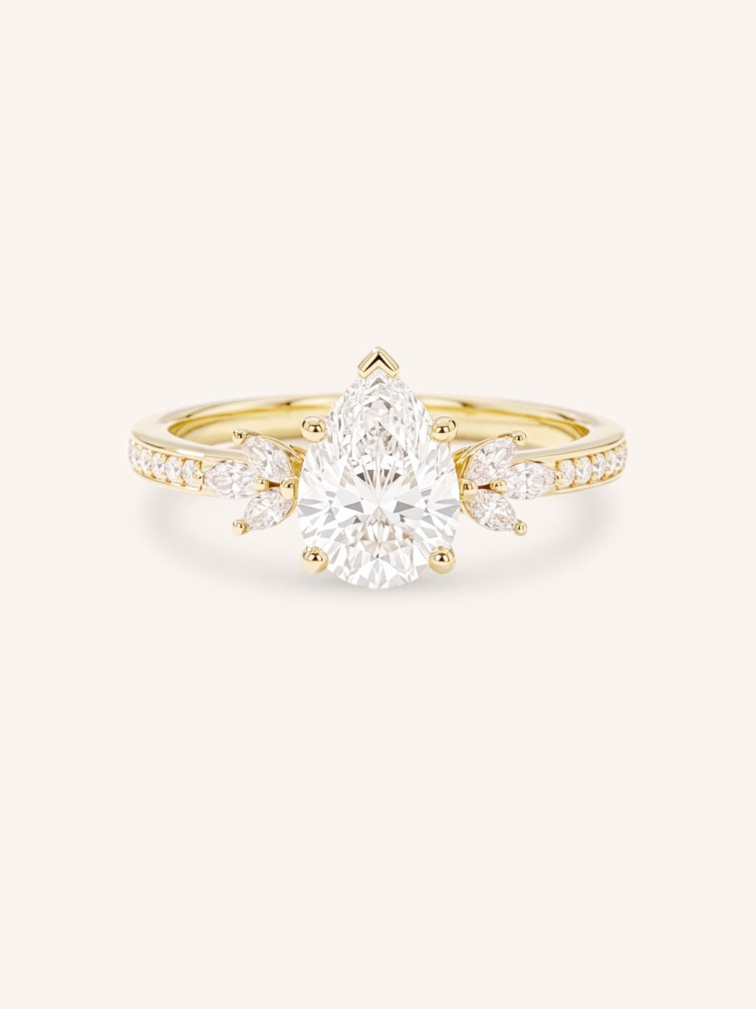 Yellow gold pear-cut diamond engagement ring with leaf-shaped diamond accents on the band, front view on white background