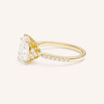 Yellow Gold pear diamond engagement ring with pave band side view on white background