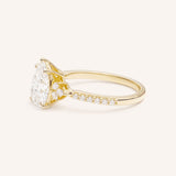 Yellow Gold pear diamond engagement ring with pave band side view on white background