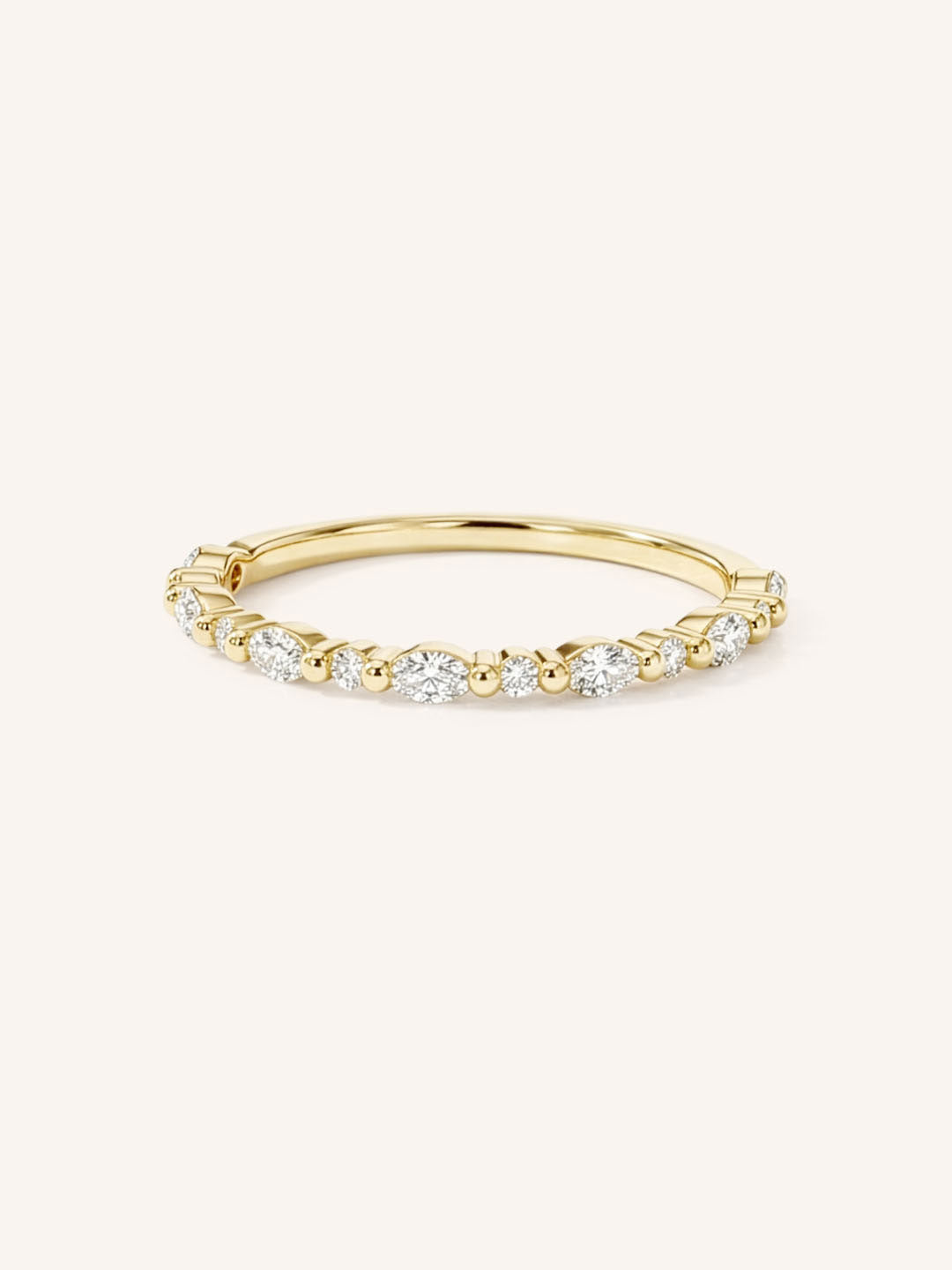 Yellow gold alternating round and marquise-cut diamond eternity wedding band front view on white background