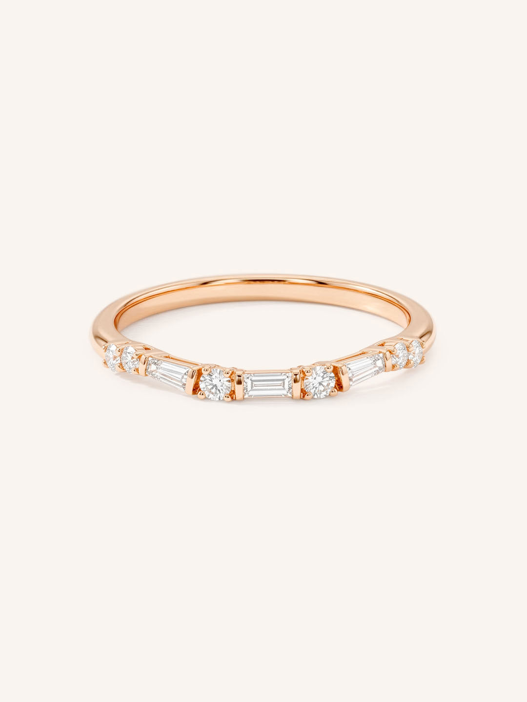 Rose gold Celia curved diamond wedding band with alternating round and baguette diamonds, front view, on white background