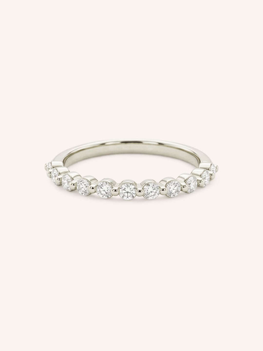 White gold round diamond eternity wedding band on white background