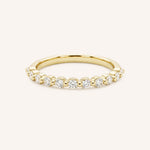 Yellow gold eternity wedding ring with a row of round diamonds, full band view, on white background