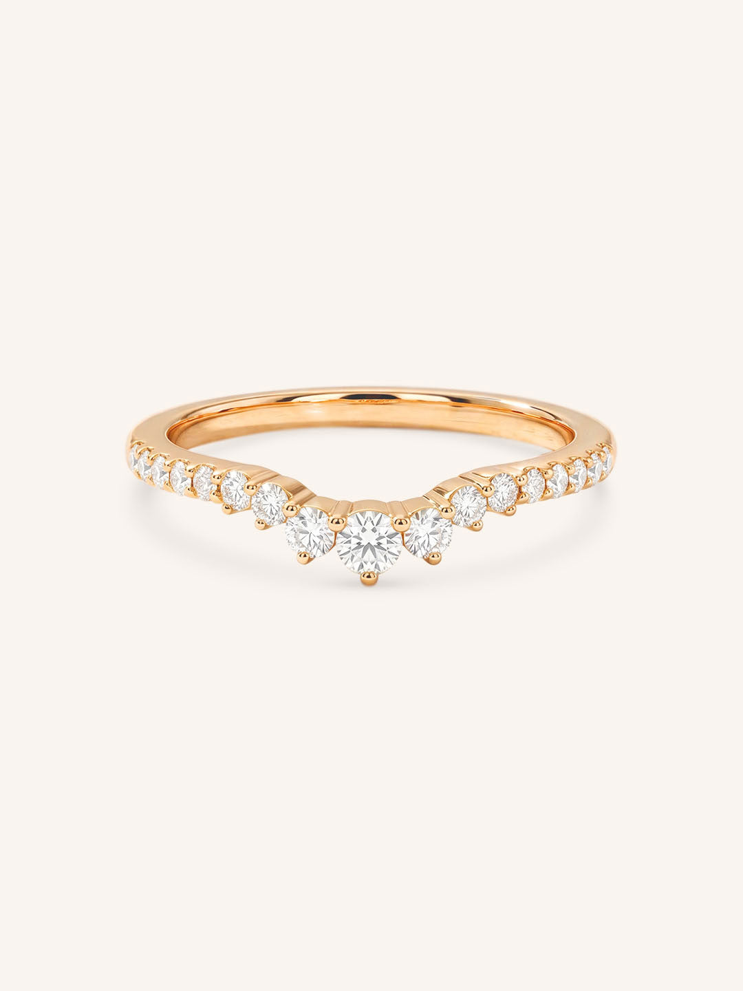 Rose gold ring with diamonds on a white background