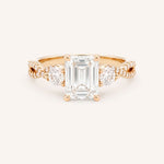 Rose gold Lindey emerald-cut three-stone diamond engagement ring with pave shoulders, front view, on white background