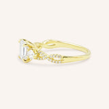 Yellow gold Lindey emerald cut three stone diamond engagement ring side view on white background
