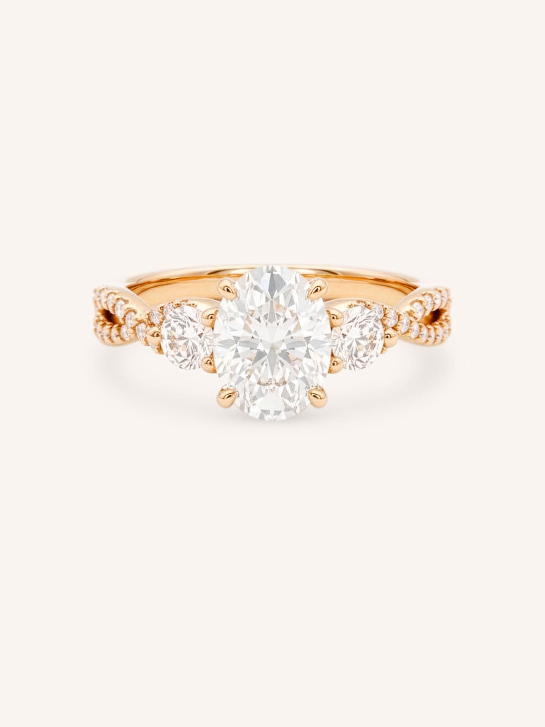 Rose gold Lindey oval three-stone diamond engagement ring with pave shoulders, front view, on white background