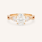 Rose gold Lindey oval three-stone diamond engagement ring with pave shoulders, front view, on white background