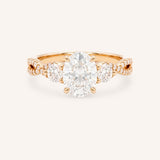 Rose gold Lindey oval three-stone diamond engagement ring with pave shoulders, front view, on white background