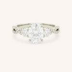 White gold oval cut three stone diamond engagement ring with pave shoulders on white background