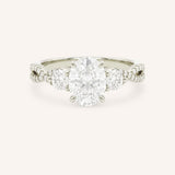 White gold oval cut three stone diamond engagement ring with pave shoulders on white background