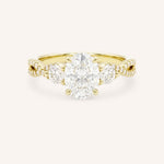 Yellow gold three-stone engagement ring with oval-cut center diamond, round side diamonds, and twisted pave diamond shank, front view, on white background