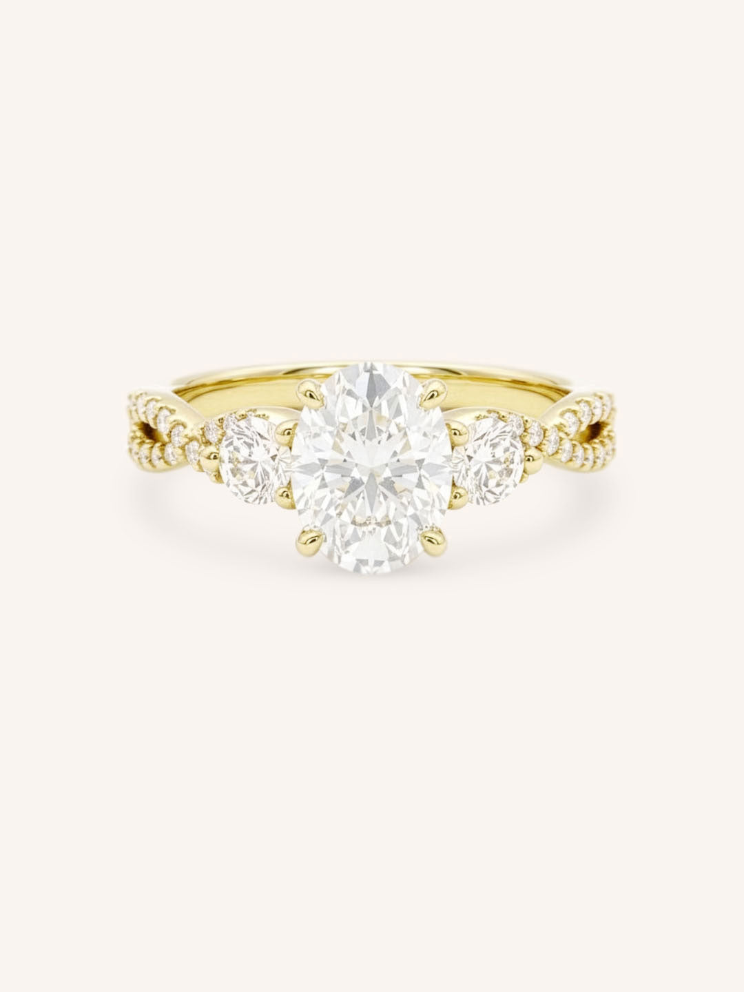 Yellow gold three-stone engagement ring with oval-cut center diamond, round side diamonds, and twisted pave diamond shank, front view, on white background