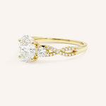 Yellow gold three-stone engagement ring with oval-cut center diamond and twisted pave diamond shank, side view, on white background
