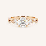 Rose gold Lindey round three-stone diamond engagement ring with pave shoulders, front view, on white background