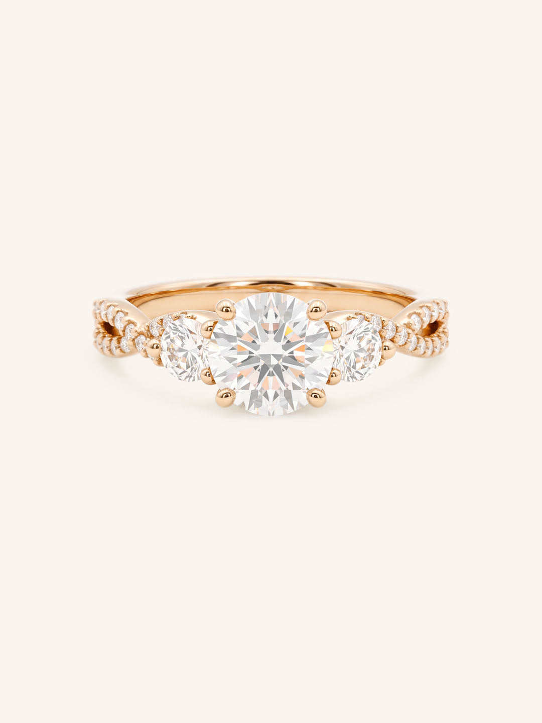 Rose gold Lindey round three-stone diamond engagement ring with pave shoulders, front view, on white background