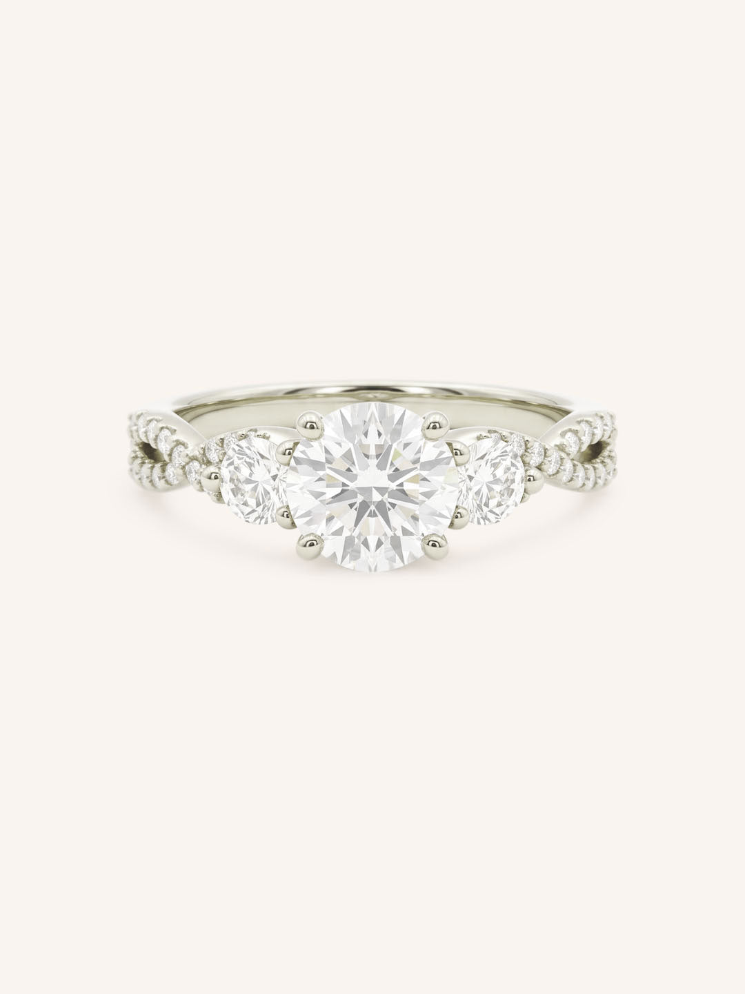 White gold round cut three stone diamond engagement ring with pave shoulders on white background
