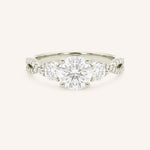 White gold round cut three stone diamond engagement ring with pave shoulders on white background